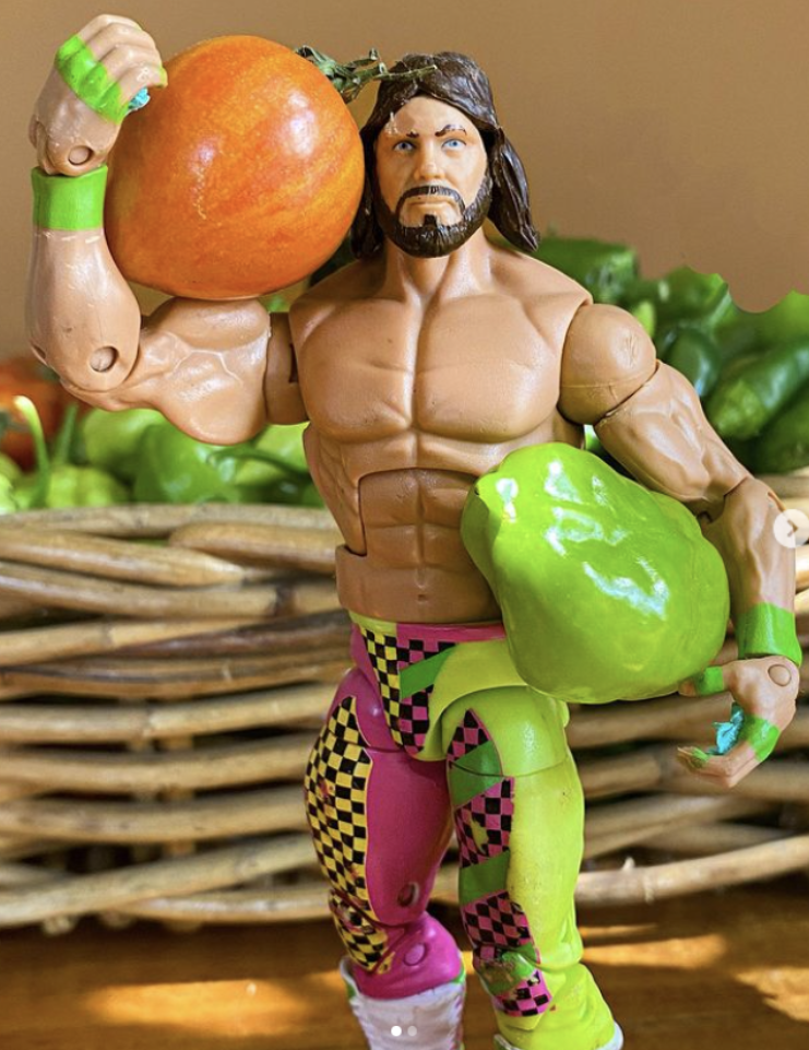 Wrestler figure holding orange and green peppers.