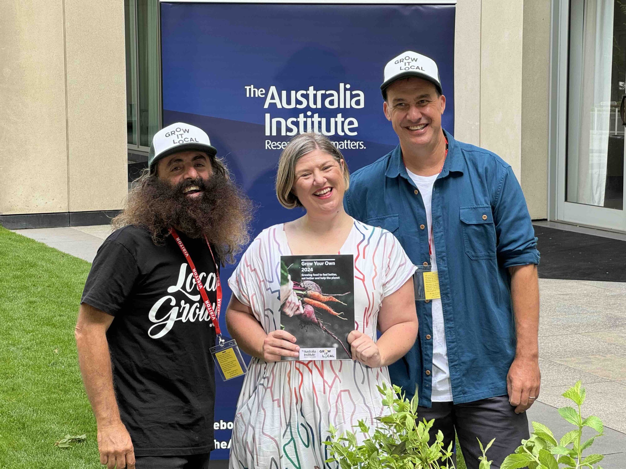 People smiling at Australia Institute event outdoors.