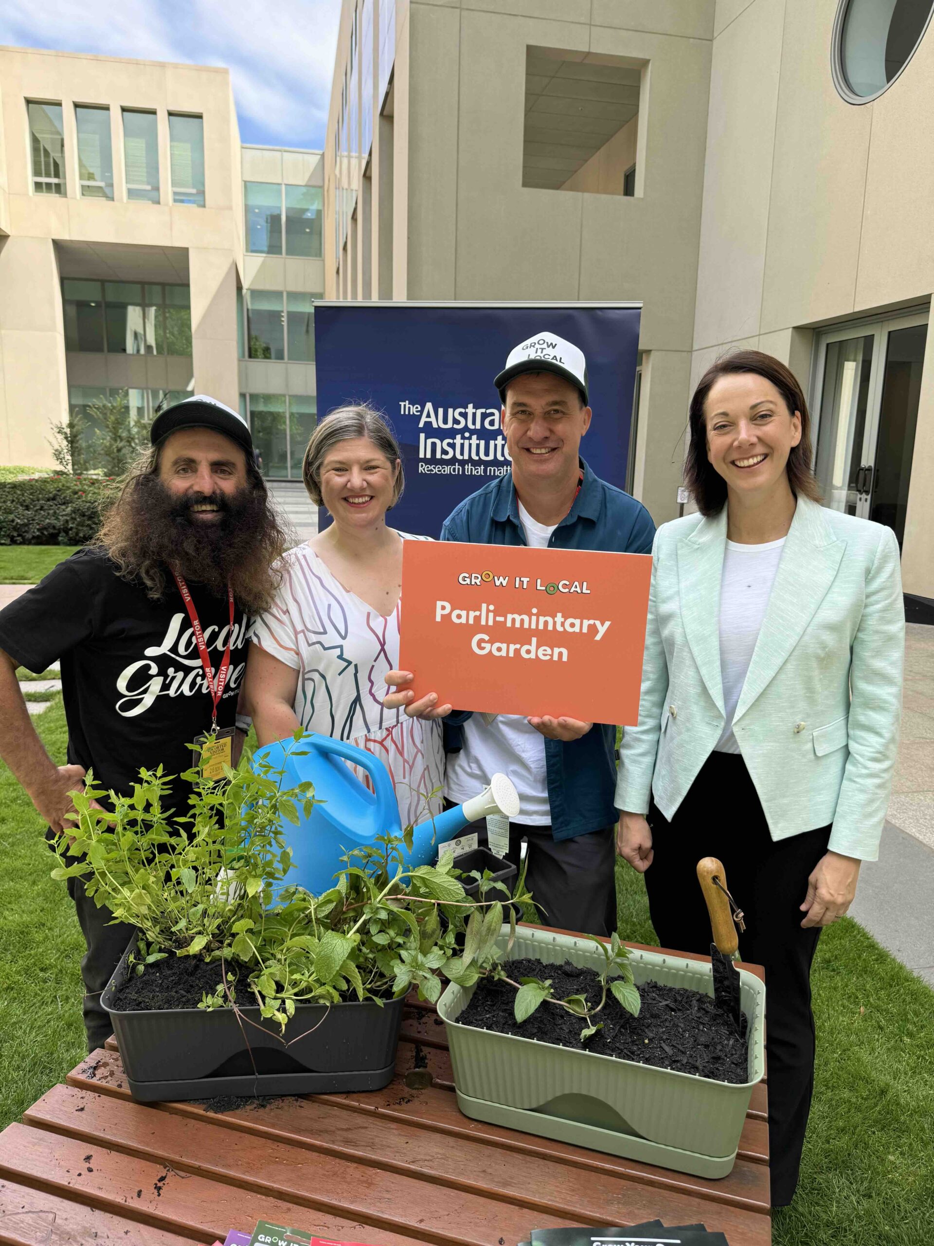 Four people promoting a community garden project.