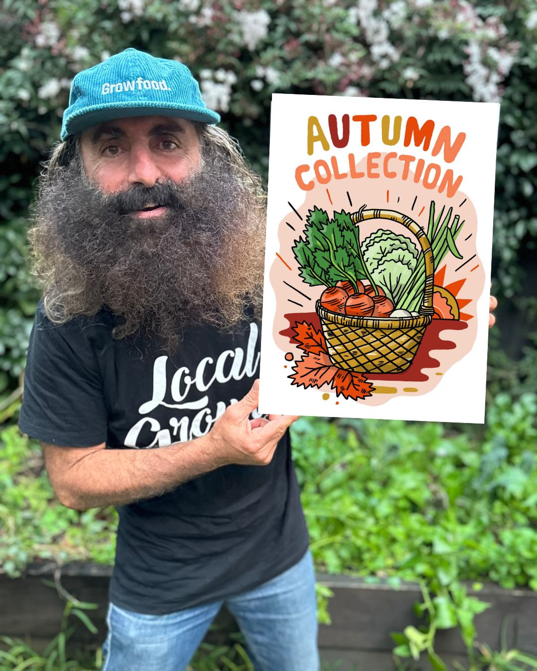 Man holding autumn vegetable collection poster outdoors.