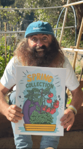 Person holding spring collection garden poster outside.