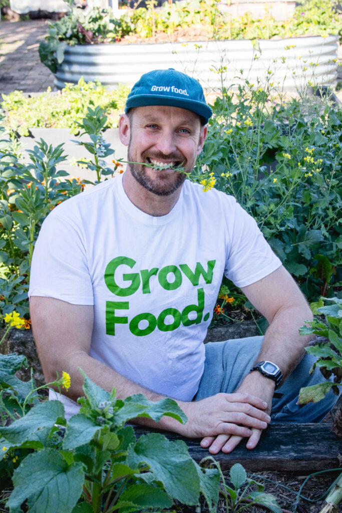 Person in garden wearing 'Grow Food' shirt