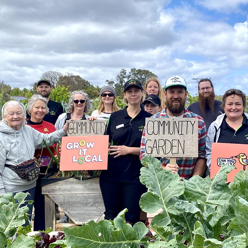 Community members at local garden, promoting sustainability.