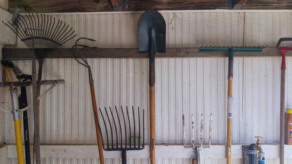 Garden tools organised on a shed wall