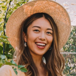 Smiling woman in sunhat outdoors