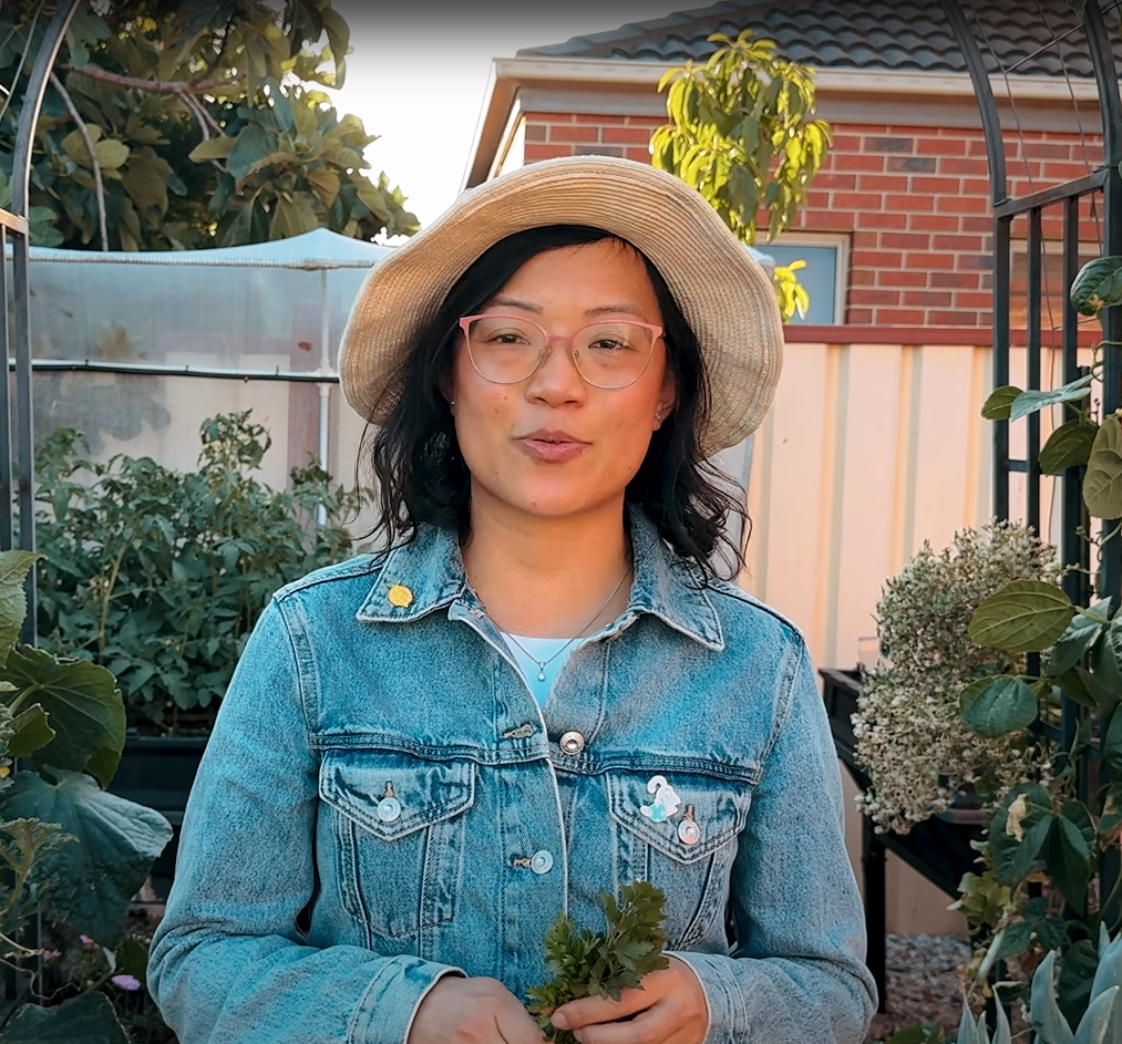 Yen in a garden wearing denim jacket